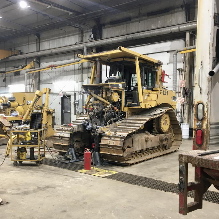 Bulldozer under maintenance in workshop
