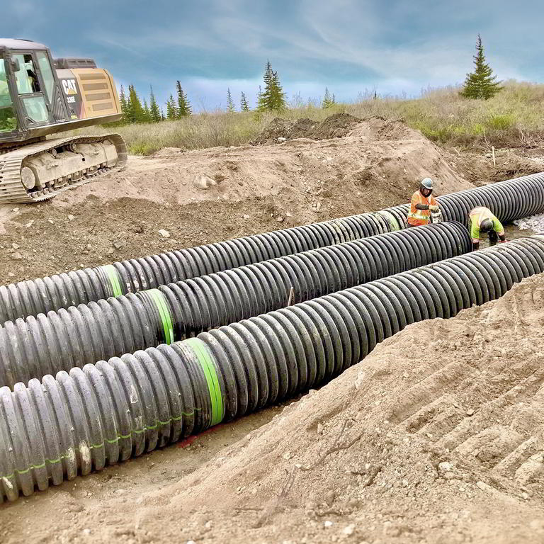 Construction workers installing pipes