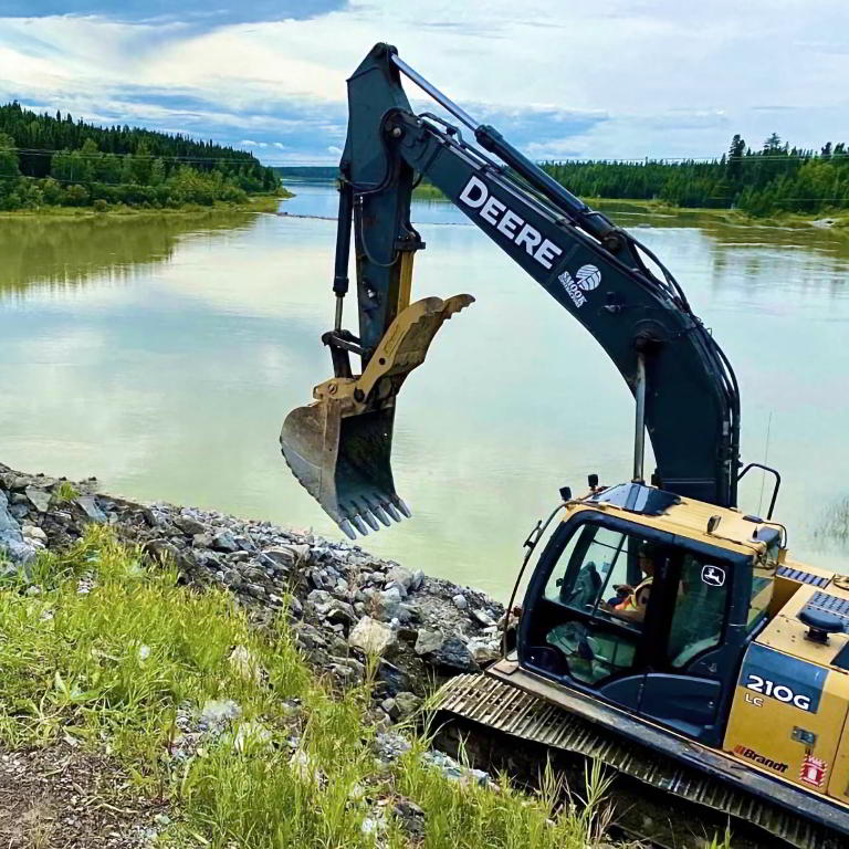 Crawler excavator by riverbank