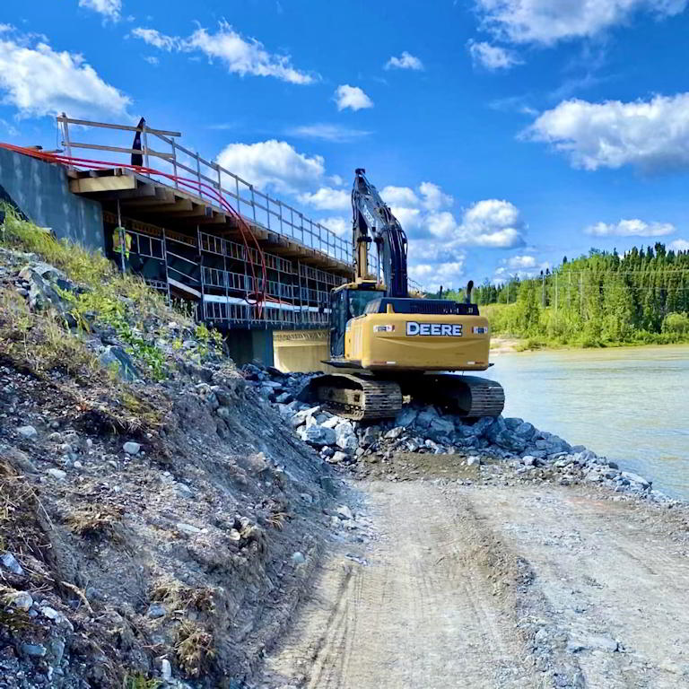 Deere excavator near bridge construction