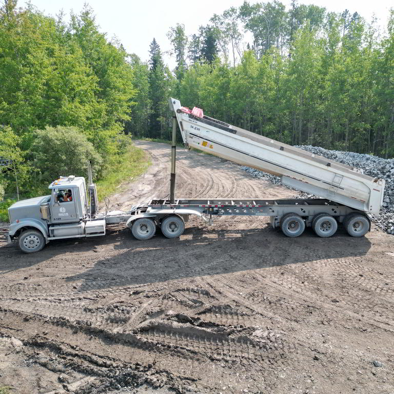 Dump truck unloading gravel