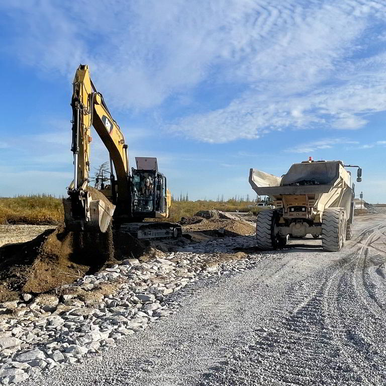 Excavator and haul truck at construction site