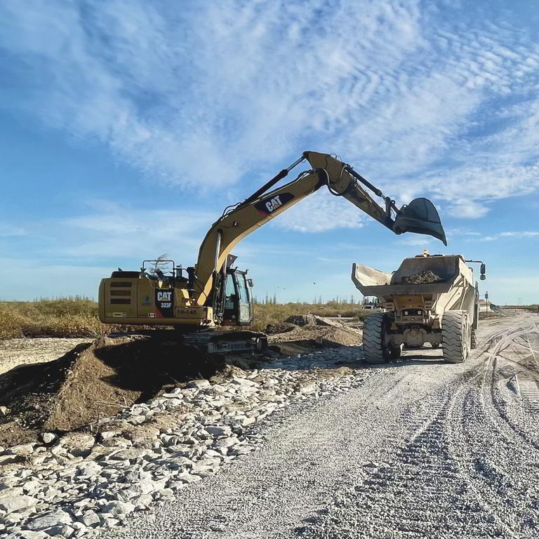 Excavator loading articulated hauler