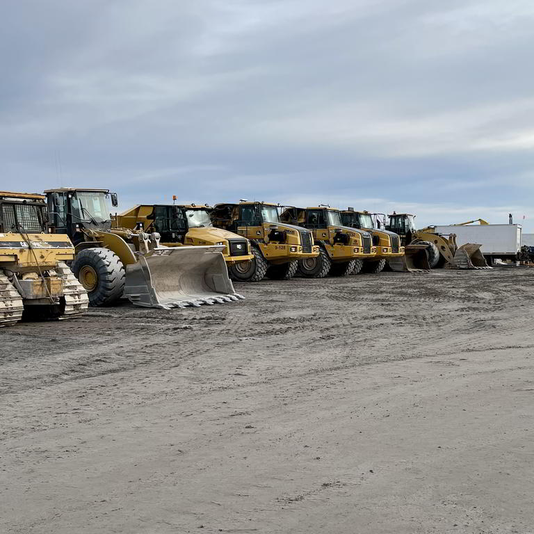 Lineup of wheel loaders at depot