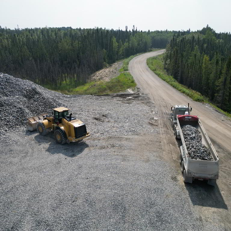 Wheel loader and dump truck on rural road