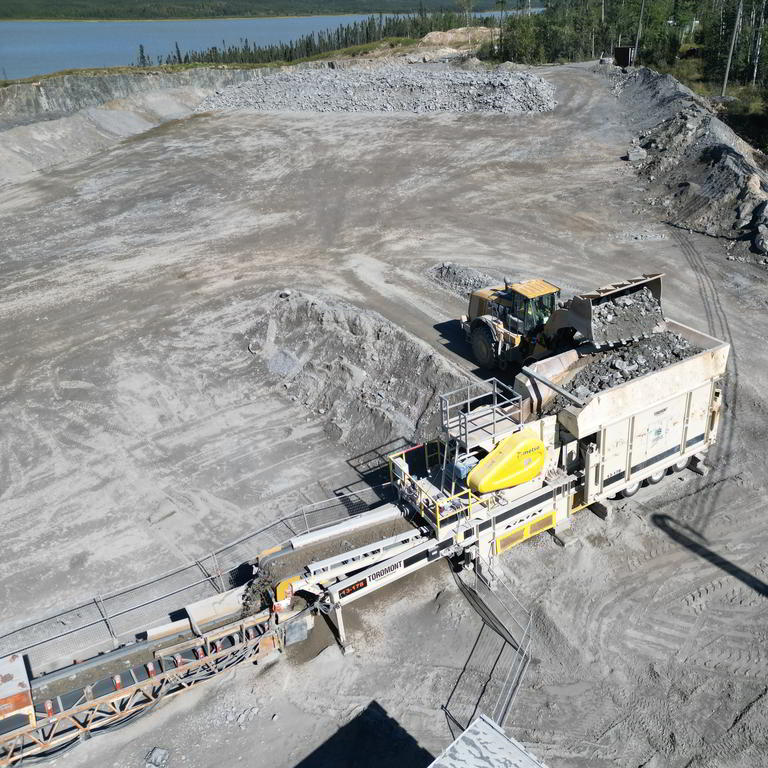 Wheel loader and rock crusher in quarry