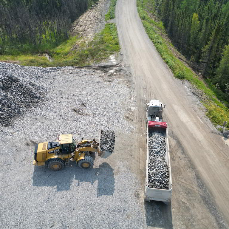 Wheel loader filling dump trailer